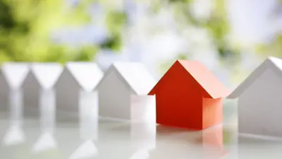row of houses with one appearing in red