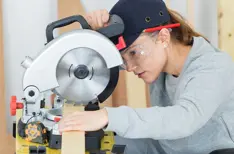woman operating a saw