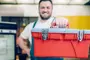 alt="Man with toolbox"